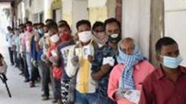 People stand in a queue to cast their votes during the first phase of Bihar assembly polls.(PTI)