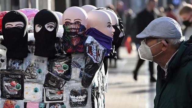 A shopper looks at face coverings displayed for sale in the city centre in Leeds on October 31. Like other European countries, coronavirus cases in the UK began to climb after lockdown measures were eased in the summer and people began to return to workplaces, schools, universities and social life. (Paul Ellis / AFP)