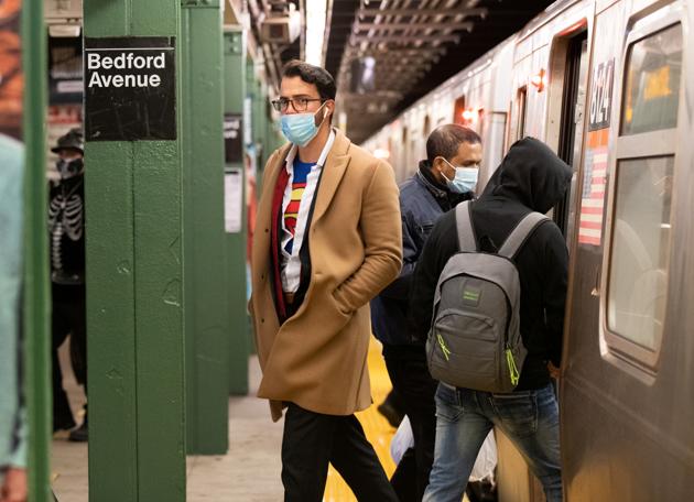 Commuters take the subway in costume on Halloween wearing masks as precautionary measure during the outbreak of the coronavirus disease in Brooklyn, New York, U.S., October 31, 2020. (REUTERS/Caitlin Ochs)