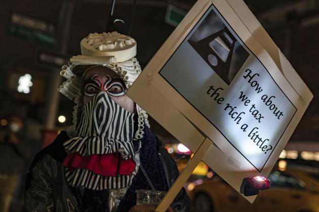 A reveler marches during the Greenwich Village Halloween Parade, Saturday, October 31, 2020, in New York. (AP Photo/Jeenah Moon)