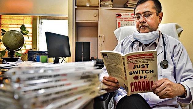 Dr. Maheshwar Prasad Chaurasia, additional medical superintendent of DDU Hospital and author of a book on the novel coronavirus. (Below) Some other books on the subject. (Sanchit Khanna/HT photo) Dr. Maheshwar Prasad Chaurasia, additional medical superintendent of DDU Hospital and author of a book on the novel coronavirus. (Below) Some other books on the subject. (Sanchit Khanna/HT photo)