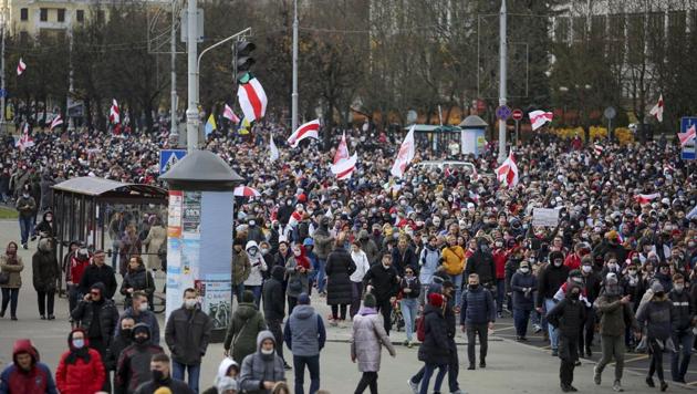 Demonstrators with old Belarusian national flags march during an opposition rally to protest the official presidential election results in Minsk, Belarus, Sunday.(AP Photo)