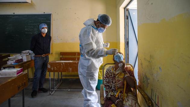 A health worker in PPE coveralls collects a swab sample for coronavirus testing, at Ambedkar Nagar in New Delhi (Photo by Amal KS/ Hindustan Times) (Amal KS/HT PHOTO) A health worker in PPE coveralls collects a swab sample for coronavirus testing, at Ambedkar Nagar in New Delhi (Photo by Amal KS/ Hindustan Times) (Amal KS/HT PHOTO)