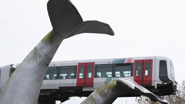 The whale's tail of a sculpture caught the front carriage of a metro train as it rammed through the end of an elevated section of rails with the driver escaping injuries. (AP) The whale's tail of a sculpture caught the front carriage of a metro train as it rammed through the end of an elevated section of rails with the driver escaping injuries. (AP)