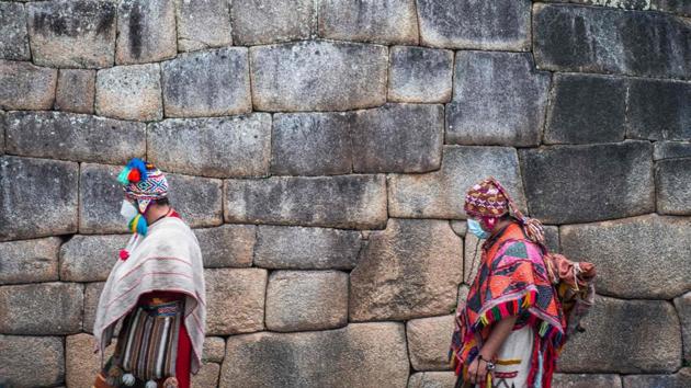 Folk performers are seen at the archaeological site of Machu Picchu on the day of its reopening on November 1. Machu Picchu, which means old mountain in Quechua, is the most enduring legacy of the Inca empire that ruled a large swathe of western South America for 100 years before the Spanish conquest in the 16th century. (Ernesto Benavides / AFP)