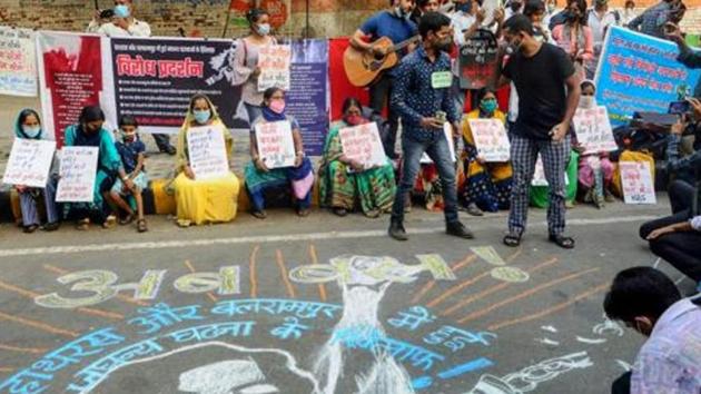 New Delhi: Demonstrators hold placards and stand near a mural on a street as they protest against the alleged gang-rape of a 19-year-old Dalit woman in Hathras (UP) in New Delhi on October 4, 2020.(PTI File Photo) New Delhi: Demonstrators hold placards and stand near a mural on a street as they protest against the alleged gang-rape of a 19-year-old Dalit woman in Hathras (UP) in New Delhi on October 4, 2020.(PTI File Photo)