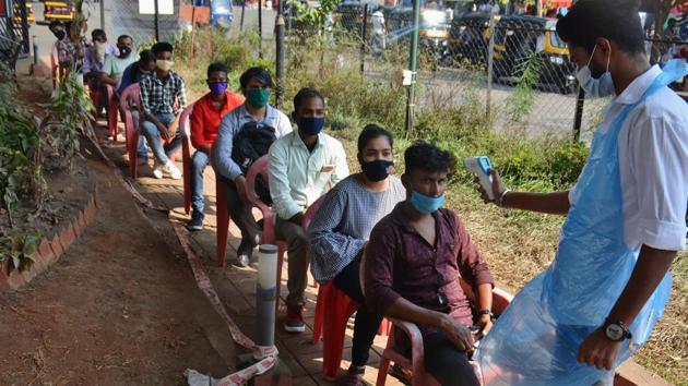 File photo: Healthcare workers conduct temperature and swab test at Covid-19 testing center.(Praful Gangurde) File photo: Healthcare workers conduct temperature and swab test at Covid-19 testing center.(Praful Gangurde)