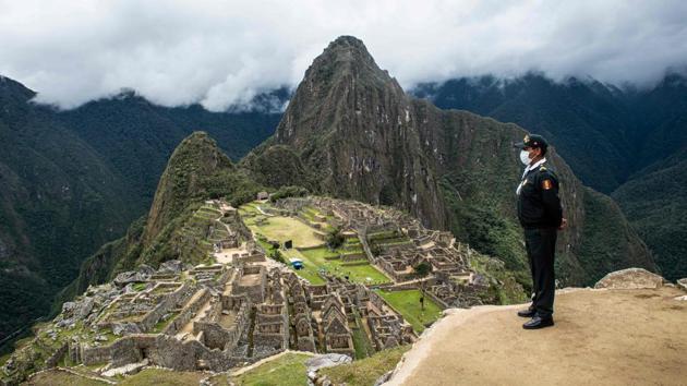 A policeman is pictured at the archaeological site of Machu Picchu, in Cusco, Peru during its reopening on November 01. The Inca citadel of Machu Picchu, the crown jewel of Peru’s tourist sites, reopened over the weekend with an ancient ritual after a nearly eight-month lockdown due to the novel coronavirus pandemic. (Ernesto Benavides / AFP)
