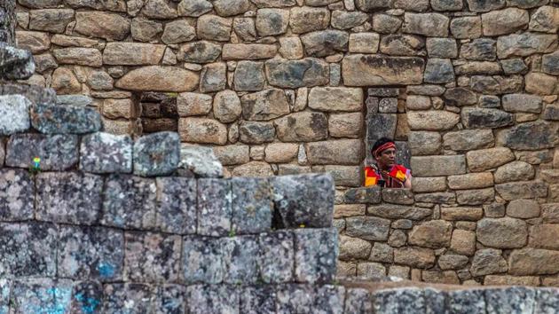 A folk dancer seen at the archaeological site of Machu Picchu on November 1. The coronavirus lockdown has been a body blow to the tens of thousands of people who make their living from the country’s tourism industry, especially those in the mountainous Cusco region where the stone citadel is located. (Ernesto Benavides / AFP)