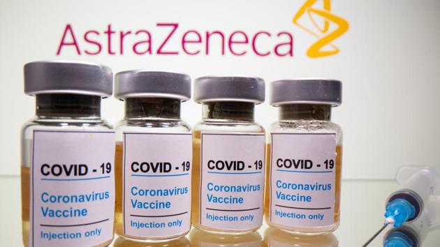 Vials with a sticker reading, "Covid-19 / Coronavirus vaccine / Injection only" and a medical syringe are seen in front of a displayed AstraZeneca logo in this illustration taken October 31, 2020 (REUTERS/Dado Ruvic/Illustration)