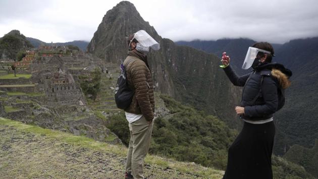 Tourists at the Incan citadel of Machu Picchu on November 1. More than 226,000 people who make crafts or work as waiters, hotel staff and taxi drivers, have been plunged into an economic abyss after tourism crashed. Merchants AP spoke to said they have lost more than two-thirds of their income. (Martin Mejia / AP)