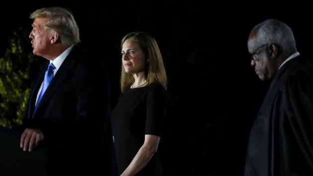 Judge Amy Coney Barrett being sworn in to serve as an associate justice of the US Supreme Court by Justice Clarence Thomas on the South Lawn of the White House.(REUTERS)