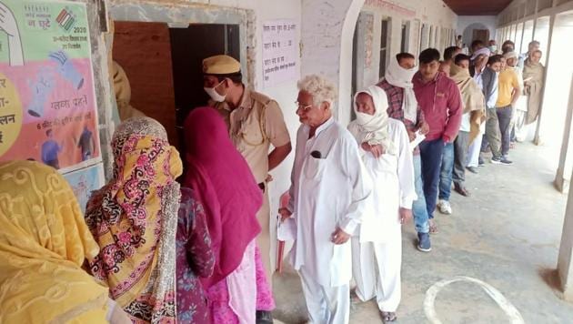 Voters outside a polling booth in Baroda in Haryana’s Sonepat district. (HT PHOTO) Voters outside a polling booth in Baroda in Haryana’s Sonepat district. (HT PHOTO)