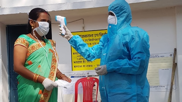 A voter undergoes thermal screening at a polling booth before voting in the Marwahi bypoll in Chhatisgarh. (HT PHOTO) A voter undergoes thermal screening at a polling booth before voting in the Marwahi bypoll in Chhatisgarh. (HT PHOTO)