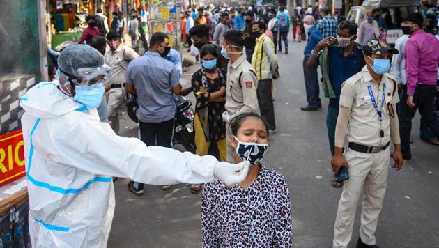 A heath worker takes a nasal swab sample from a girl to test for coronavirus infection, at Sadar bazar, in New Delhi on November 3, 2020. (Amal KS/HT PHOTO) A heath worker takes a nasal swab sample from a girl to test for coronavirus infection, at Sadar bazar, in New Delhi on November 3, 2020. (Amal KS/HT PHOTO)