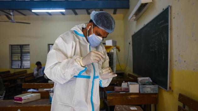 A health worker in PPE coveralls works with swab samples collected for coronavirus tests. The second round of door-to-door survey under state’s “My Family, My Responsibility” campaign has found less than 200 Covid patients from the over 25 lakh residents of Pune city screened for symptoms. (HT PHOTO (FOR REPRESENTATIONAL PURPOSE ONLY)) A health worker in PPE coveralls works with swab samples collected for coronavirus tests. The second round of door-to-door survey under state’s “My Family, My Responsibility” campaign has found less than 200 Covid patients from the over 25 lakh residents of Pune city screened for symptoms. (HT PHOTO (FOR REPRESENTATIONAL PURPOSE ONLY))