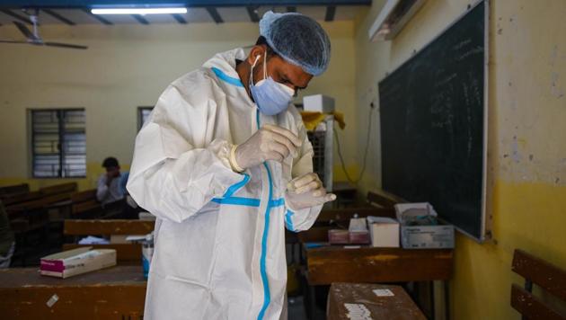 A health worker in PPE coveralls works with swab samples collected for coronavirus tests, at Ambedkar Nagar in New Delhi (Photo by Amal KS/ Hindustan Times) A health worker in PPE coveralls works with swab samples collected for coronavirus tests, at Ambedkar Nagar in New Delhi (Photo by Amal KS/ Hindustan Times)