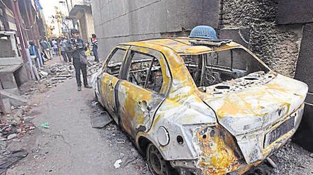 A video journalist stands near a car burnt during last week’s violence in north-east Delhi over the Citizenship Amendment Act (CAA), at Shiv Vihar, in New Delhi, India, on Tuesday, March 3, 2020.(Raj K Raj/HT PHOTO) A video journalist stands near a car burnt during last week’s violence in north-east Delhi over the Citizenship Amendment Act (CAA), at Shiv Vihar, in New Delhi, India, on Tuesday, March 3, 2020.(Raj K Raj/HT PHOTO)