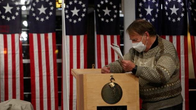A poll worker takes ballots from a box shortly after midnight for the U.S. presidential election at the Hale House at Balsams Hotel in the hamlet of Dixville Notch, New Hampshire.(REUTERS)
