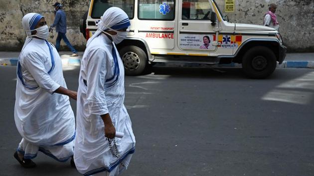 Nuns walk back after collecting swab test reports near a mobile Covid-19 testing clinic in Kolkata on October 30. (Adibyangshu Sarkar / AFP) Nuns walk back after collecting swab test reports near a mobile Covid-19 testing clinic in Kolkata on October 30. (Adibyangshu Sarkar / AFP)