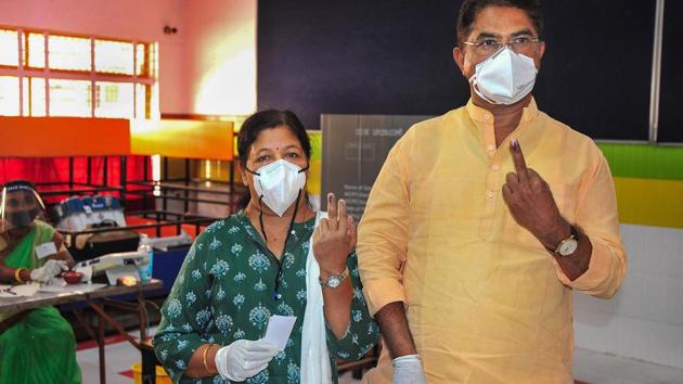 Bengaluru: Karnataka Revenue Minister R Ashoka and his wife Pramilarani show their fingers marked with indelible ink after casting their votes for the state by-polls, at Rajarajeshwari Nagar in Bengaluru. (PTI) Bengaluru: Karnataka Revenue Minister R Ashoka and his wife Pramilarani show their fingers marked with indelible ink after casting their votes for the state by-polls, at Rajarajeshwari Nagar in Bengaluru. (PTI)
