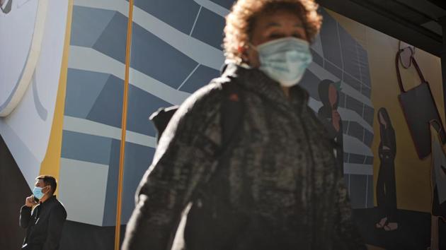 People wearing face masks to help curb the spread of the coronavirus walk through the capital city's popular shopping mall in Beijing, (AP Photo/Andy Wong) People wearing face masks to help curb the spread of the coronavirus walk through the capital city's popular shopping mall in Beijing, (AP Photo/Andy Wong)