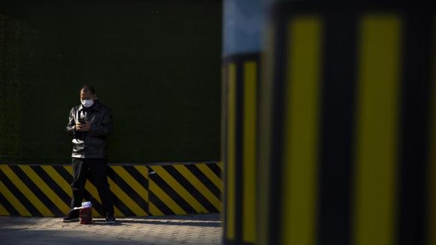 A man wearing a face mask to protect against the coronavirus uses his smartphone along a street during the morning rush hour in Beijing, Tuesday, Nov. 3, 2020. (AP) A man wearing a face mask to protect against the coronavirus uses his smartphone along a street during the morning rush hour in Beijing, Tuesday, Nov. 3, 2020. (AP)