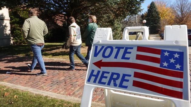 A sign directs towards a polling station at the Beloit Historical Society in Beloit, Wisconsin on November 3. Voters braved long lines and the threat of the virus to cast ballots as they chose between two starkly different visions of America for the next four years. (Scott Olson / Getty Images / AFP) A sign directs towards a polling station at the Beloit Historical Society in Beloit, Wisconsin on November 3. Voters braved long lines and the threat of the virus to cast ballots as they chose between two starkly different visions of America for the next four years. (Scott Olson / Getty Images / AFP)