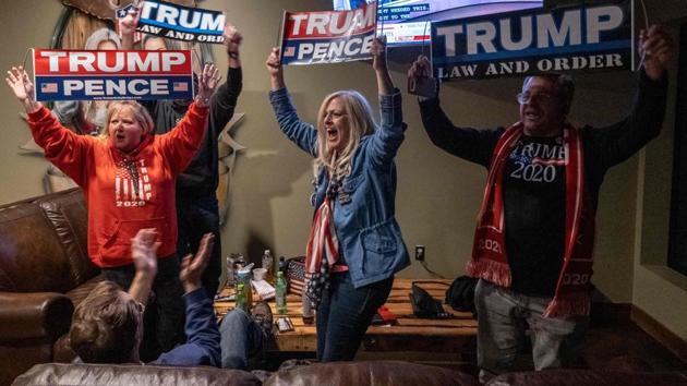 Supporters of Donald Trump celebrate Ohio being called for Donald Trump at a Republican watch party in Michigan on November 3. Some states began counting absentee ballots days before Election Day — and had definitive results within hours of the polls closing. Elsewhere, absentee ballots have thrown into doubt historical norms, making the arc of the race harder to determine. (Seth Herald / AFP) Supporters of Donald Trump celebrate Ohio being called for Donald Trump at a Republican watch party in Michigan on November 3. Some states began counting absentee ballots days before Election Day — and had definitive results within hours of the polls closing. Elsewhere, absentee ballots have thrown into doubt historical norms, making the arc of the race harder to determine. (Seth Herald / AFP)