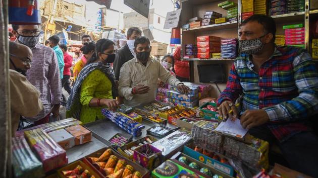 People look to buy firecrackers from a shop ahead of Diwali festival at Sadar bazar, in New Delhi, India, on Tuesday, November 3, 2020. (Amal KS/HT PHOTO) People look to buy firecrackers from a shop ahead of Diwali festival at Sadar bazar, in New Delhi, India, on Tuesday, November 3, 2020. (Amal KS/HT PHOTO)