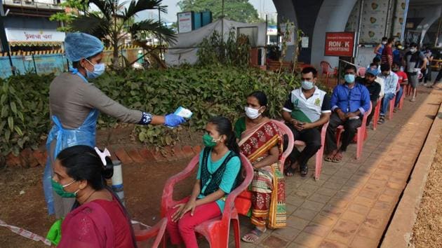 Health care workers check temperature and collect swab sample at Covid-19 testing center at Manpada GB Road at Thane, Mumbai, India, on Tuesday, November 03, 2020.(Praful Gangurde/HT photo)