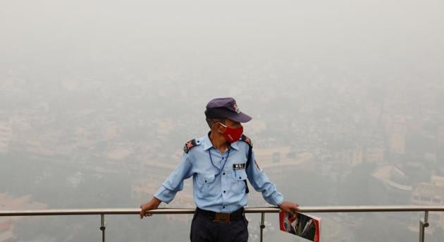 A security guard stands on a building terrace amid deteriorating weather in New Delhi on November 4. In a departure from a trend which saw India’s daily infections keeping below 50,000 since October 25 according to a Reuters tally, the country registered 50,210 fresh cases, health ministry data for November 5 revealed. (Adnan Abidi / REUTERS)