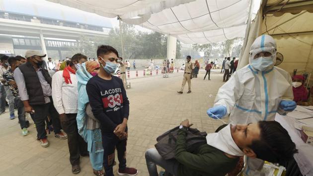A health worker conducts Covid-19 test at Anand Vihar Bus Terminal, as coronavirus cases surge across the national capital, in New Delhi on Wednesday.(PTI Photo) A health worker conducts Covid-19 test at Anand Vihar Bus Terminal, as coronavirus cases surge across the national capital, in New Delhi on Wednesday.(PTI Photo)