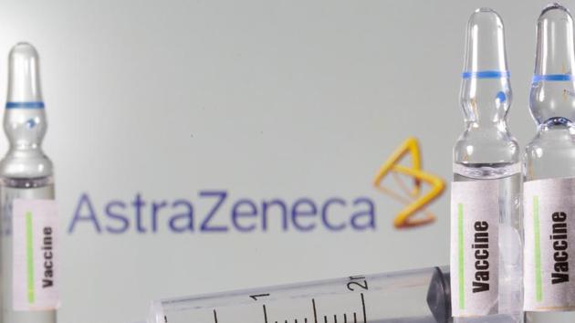 A test tube labelled with the Vaccine is seen in front of AstraZeneca logo(Reuters Photo)