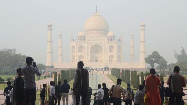 Tourists at the Taj Mahal, shrouded in smog, in Agra on November 5. The number of new infections reported on November 5 registered an 8.5 % jump from a day prior and a 31% jump in comparison with 38,310 infections registered on November 3 — the lowest in the recent past. (PTI) Tourists at the Taj Mahal, shrouded in smog, in Agra on November 5. The number of new infections reported on November 5 registered an 8.5 % jump from a day prior and a 31% jump in comparison with 38,310 infections registered on November 3 — the lowest in the recent past. (PTI)