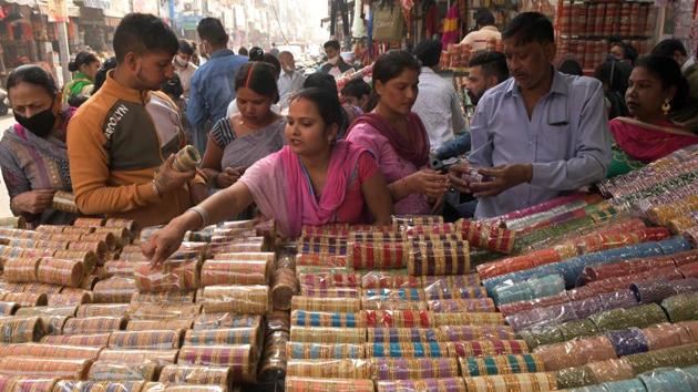 People, many not wearing face masks, shop for bangles in a market on the eve of Karva Chauth, in Amritsar on November 3. The rise in the number of daily infections indicates that the spread of the infection is unabated amid the festive season, but with recoveries also going up, the number of active cases remains under 5 lakh. (Narinder Nanu / AFP) People, many not wearing face masks, shop for bangles in a market on the eve of Karva Chauth, in Amritsar on November 3. The rise in the number of daily infections indicates that the spread of the infection is unabated amid the festive season, but with recoveries also going up, the number of active cases remains under 5 lakh. (Narinder Nanu / AFP)