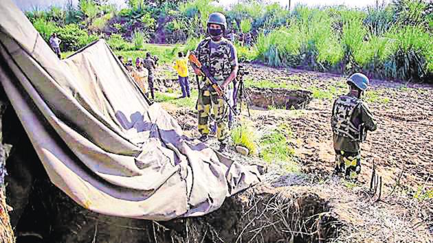 BSF personnel stand near a tunnel, originating from Pakistan, beneath the Indo-Pak international border fence, in J&K's Samba district, detected on August 29. (PTI)