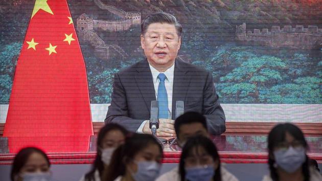 Volunteers watch video screens showing Chinese President Xi Jinping delivering an address to the opening ceremony of the China International Import Expo in Shanghai, Wednesday. (AP) Volunteers watch video screens showing Chinese President Xi Jinping delivering an address to the opening ceremony of the China International Import Expo in Shanghai, Wednesday. (AP)
