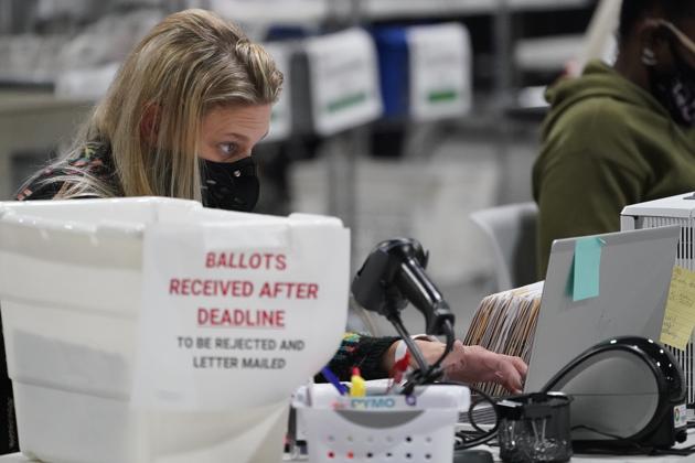 Officials work on ballots at the Gwinnett County Voter Registration and Elections Headquarters, Friday, Nov. 6, 2020. (AP Photo)