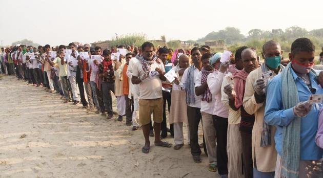 Voters show their voter ids while standing in a queue to cast their vote at a polling booth during the second phase of Bihar assembly elections, at Diyara Manash Gaon, in Danapur, Patna, Bihar, India, on Tuesday, Nov. 3, 2020 (Photo by Santosh Kumar/ Hindustan Times) Voters show their voter ids while standing in a queue to cast their vote at a polling booth during the second phase of Bihar assembly elections, at Diyara Manash Gaon, in Danapur, Patna, Bihar, India, on Tuesday, Nov. 3, 2020 (Photo by Santosh Kumar/ Hindustan Times)