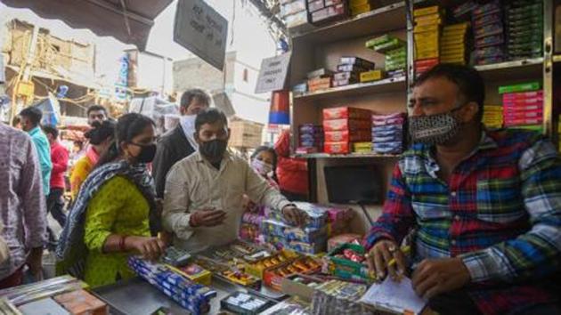 People look to buy firecrackers from a shop ahead of Diwali festival at Sadar bazar, in New Delhi, India, on Tuesday, November 3, 2020.(Amal KS/HT PHOTO)