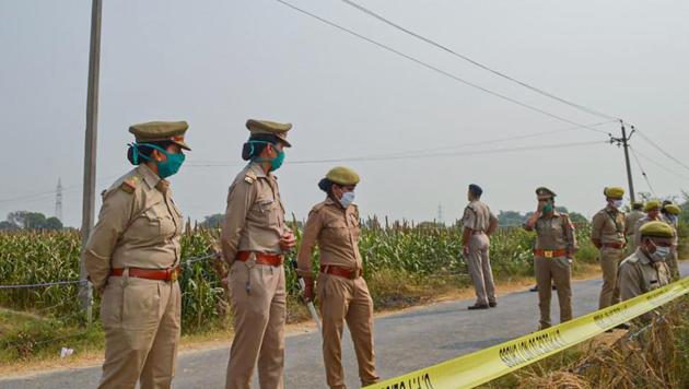 Police personnel stand guard as CBI officials (unseen) investigate the case of a 19-year-old Dalit woman who died after being gang-raped, in Hathras, Tuesday, Oct. 13, 2020.(PTI)