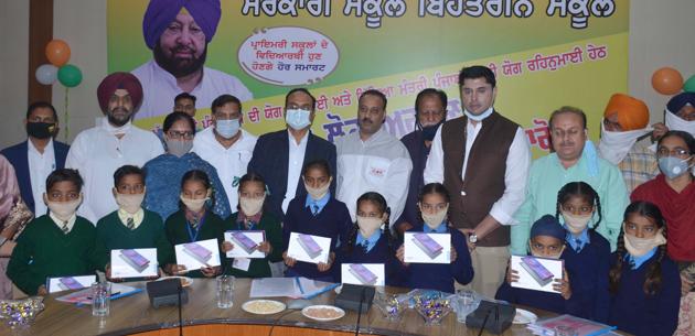Officials during the distribution of tablets at Bachat Bhawan in Ludhiana on Saturday. (Gurpreet Singh/HT) Officials during the distribution of tablets at Bachat Bhawan in Ludhiana on Saturday. (Gurpreet Singh/HT)
