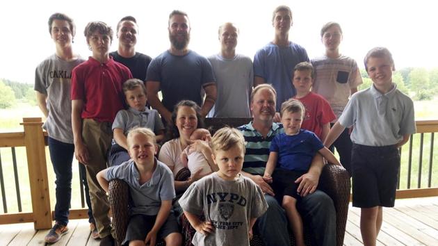 The Schwandt family poses for a photo at their farm in Lakeview, Mich. Standing from left are Tommy, Calvin, Drew, Tyler, Zach, Brandon, Gabe, Vinny and Wesley. Seated, starting at upper left are Charlie, Luke, mother Kateri holding Finley, father Jay with Tucker and Francisco in the foreground. The 14-boy family has welcomed their first daughter nearly three decades after the birth of their first child. Kateri Schwandt gave birth to Maggie Jayne Schwandt. (AP) The Schwandt family poses for a photo at their farm in Lakeview, Mich. Standing from left are Tommy, Calvin, Drew, Tyler, Zach, Brandon, Gabe, Vinny and Wesley. Seated, starting at upper left are Charlie, Luke, mother Kateri holding Finley, father Jay with Tucker and Francisco in the foreground. The 14-boy family has welcomed their first daughter nearly three decades after the birth of their first child. Kateri Schwandt gave birth to Maggie Jayne Schwandt. (AP)