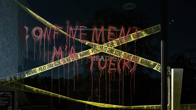 The window of closed shop displays a mock crime scene ribbon and a painted slogan reading “lockdown killed me” in Bordeaux on November 5. The second lockdown risks France tipping back to the 13.8% slump in the economy that came after the country was put under one of Europe’s strictest lockdowns during the March-April period earlier this year. (Philippe Lopez / AFP)