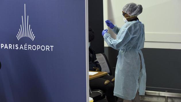 A health worker uses a cotton swab to test a person for coronavirus infection at Orly airport near Paris on November 6. In addition to lockdown measures, French Health Minister Olivier Veran also announced on November 6, that the government had sanctioned 1.6 million rapid virus testing kits for care homes across the country, to ramp up testing and tracking. (Eric Piermont / AFP)
