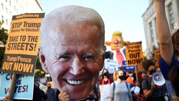 A supporter holds a cardboard cutout of Democratic US presidential nominee Joe Biden during a march from McPherson square to the White House after Election Day in Washington.(REUTERS)