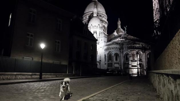A dog runs in an empty street near the Sacre-Coeur basilica in Paris on November 3. As many as 1,661,853 people have been infected with the coronavirus so far in the country while 39,865 people have lost their lives battling the infection according to latest figures. (Alain Jocard / AFP)