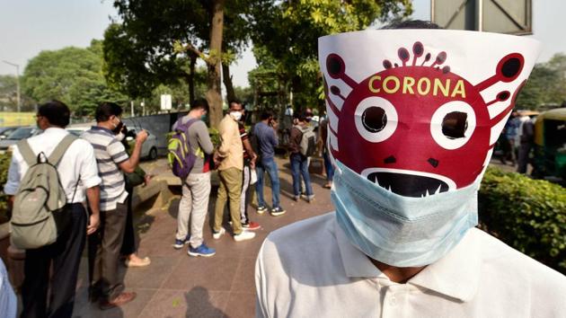A volunteer takes part in a Covid-19 awareness programme at Connaught Place as coronavirus cases rise across the national capital in New Delhi on November 6. 438,529 people have contracted Covid-19 in Delhi according to the health bulletin on November 9. 6,989 people have succumbed to the disease so far. (Manvender Vashisht / PTI )