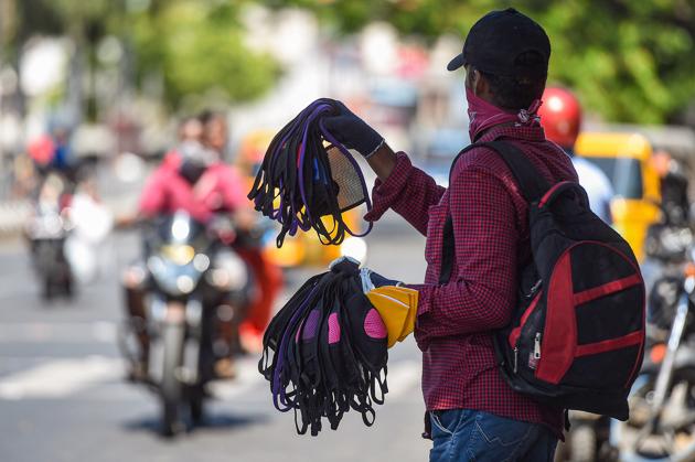 A vendor?sells masks on a street during the Covid-19 lockdown in Chennai on June 15.(PTI FILE)